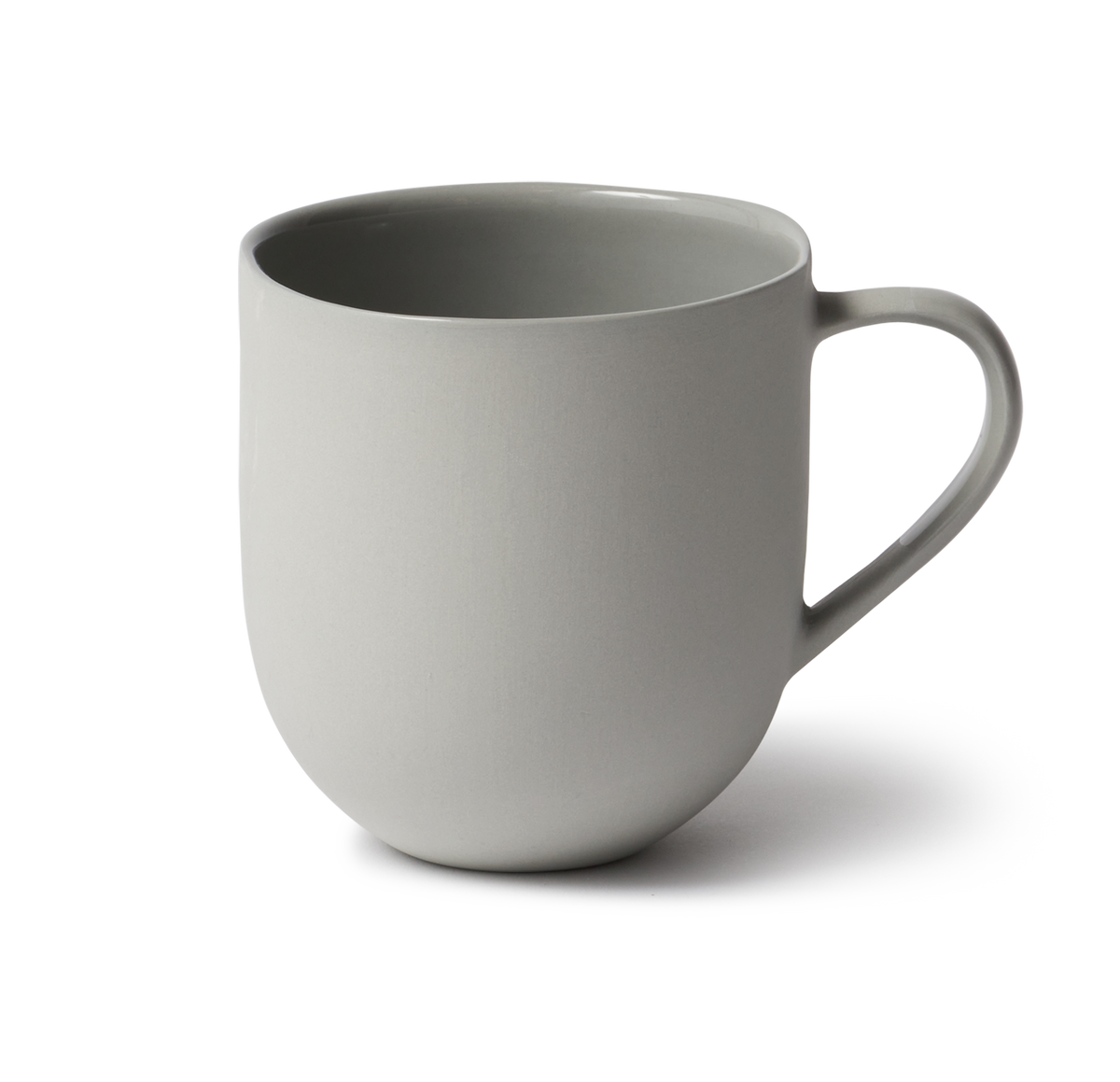 Handmade porcelain mug with flared shape, glazed handle, and smooth stone-like exterior, perfect for tea or coffee.