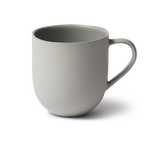 Handmade porcelain mug with flared shape, glazed handle, and smooth stone-like exterior, perfect for tea or coffee.