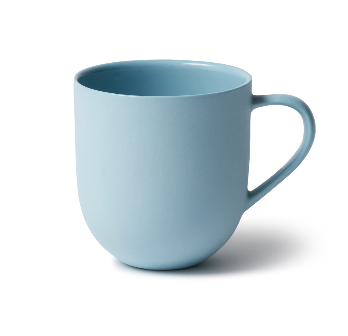 Handmade porcelain mug with flared shape, glazed handle, and smooth stone-like exterior, perfect for tea or coffee.