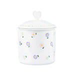 "Hand painted porcelain candy jar with a daisy design, handmade in Paris, perfect for storing treats or as a decorative accent."