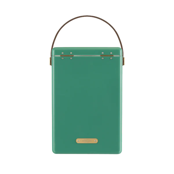 FIELDBAR Drinks Box hardcase cooler with leather handle and brass-coated hardware, showcasing its sleek design and Pantone 10C color, placed on an outdoor surface. Drinks Box / parisian green