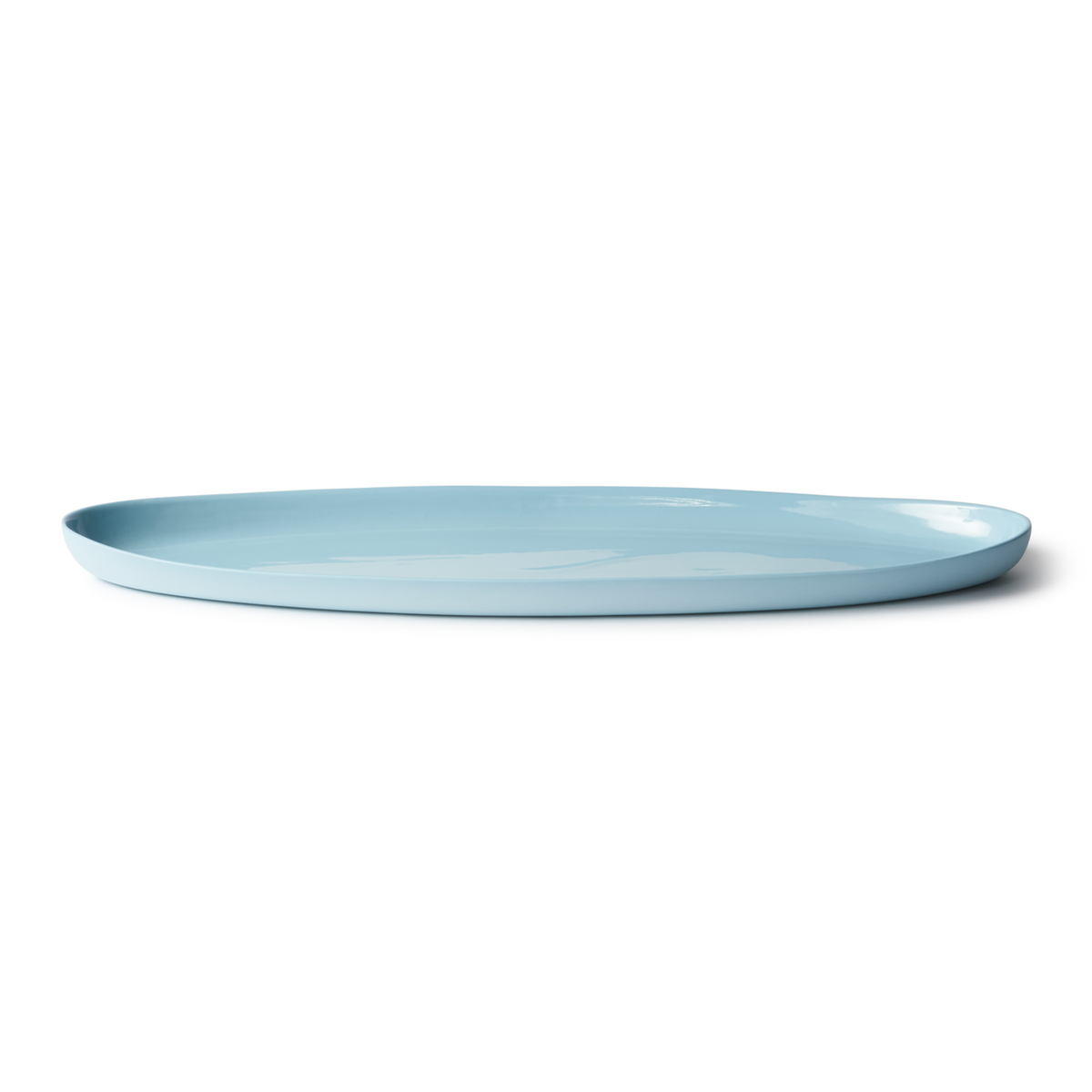 Handmade Oval Shaped Fish Platter in porcelain, designed for serving fish, snacks, or dips. Features a smooth, stone-like exterior and clear glazed interior.