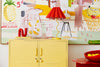 Yellow cabinet with a colorful abstract painting in the background