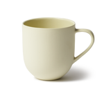 Handmade porcelain mug with flared shape, glazed handle, and smooth stone-like exterior, perfect for tea or coffee.