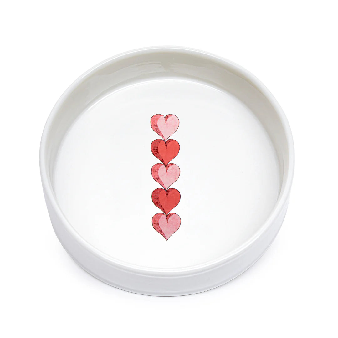  "Front view of the Five Hearts Ramekin, featuring five heart-shaped illustrations and an enameled porcelain finish."