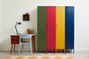 Colorful lockers next to a desk with a lamp and books in a room.