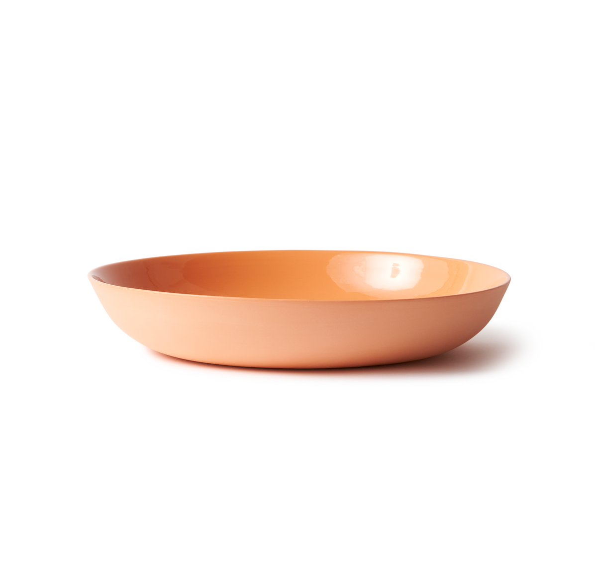 Handmade Pebble Bowl Large - Orange in porcelain, perfect for serving or display. Features a smooth stone-like exterior and clear glazed interior.