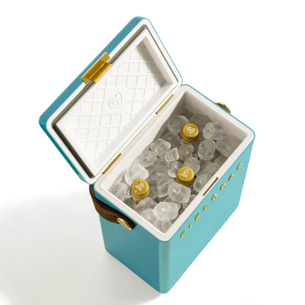 FIELDBAR Drinks Box hardcase cooler with leather handle and brass-coated hardware, showcasing its sleek design and Pantone 2241 color, placed on an outdoor surface.