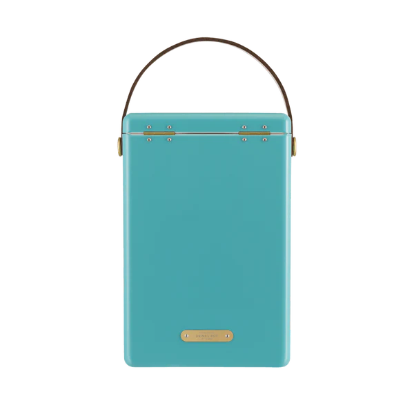 FIELDBAR Drinks Box hardcase cooler with leather handle and brass-coated hardware, showcasing its sleek design and Pantone 2241 color, placed on an outdoor surface.