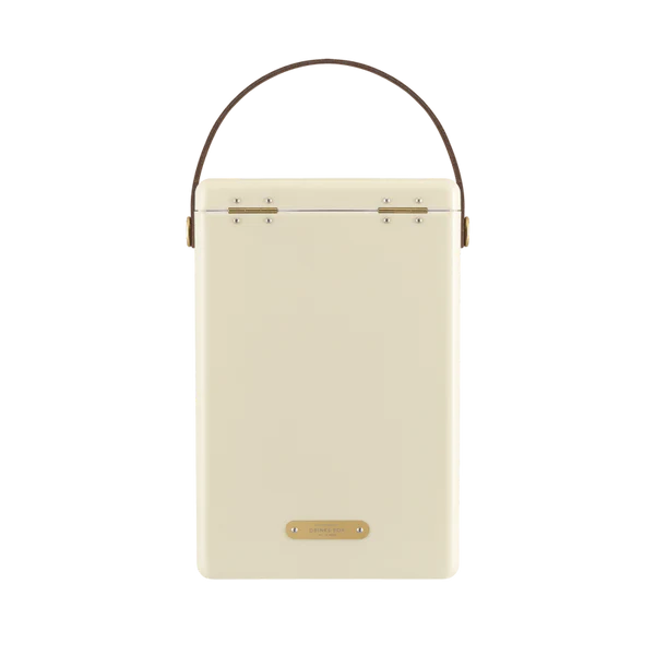 FIELDBAR Drinks Box hardcase cooler with leather handle and brass-coated hardware, showcasing its sleek design and Pantone 10C color, placed on an outdoor surface. Drinks Box / Safari White