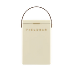 FIELDBAR Drinks Box hardcase cooler with leather handle and brass-coated hardware, showcasing its sleek design and Pantone 10C color, placed on an outdoor surface. Drinks Box / Safari White
