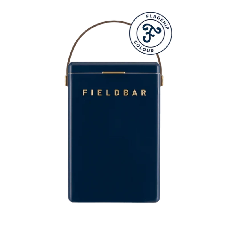 FIELDBAR Drinks Box hardcase cooler with leather handle and brass-coated hardware, showcasing its sleek design and Pantone 10C color, placed on an outdoor surface. Drinks Box / Sea Boat Blue