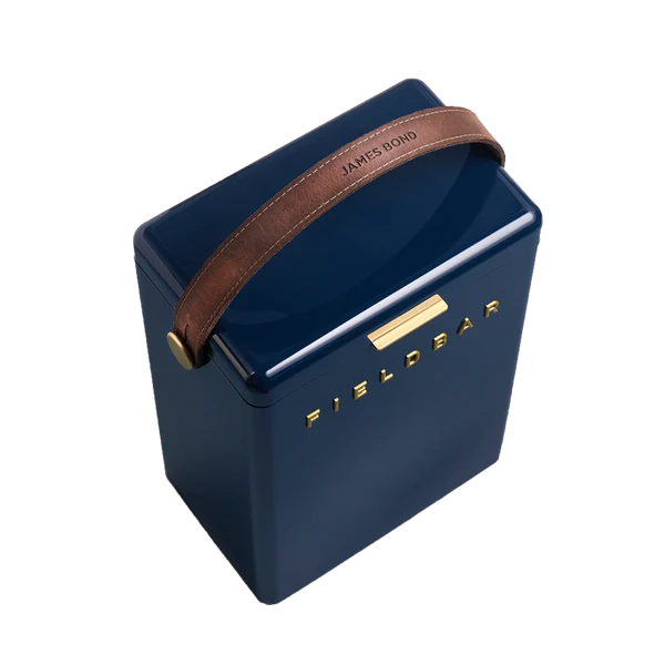 FIELDBAR Drinks Box hardcase cooler with leather handle and brass-coated hardware, showcasing its sleek design and Pantone 10C color, placed on an outdoor surface. Drinks Box / Sea Boat Blue